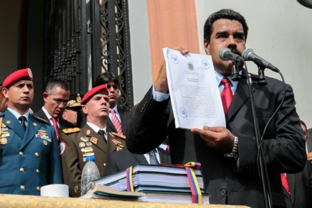Venezuelan President Nicolas Maduro shows the books with the national budget for 2017 at t