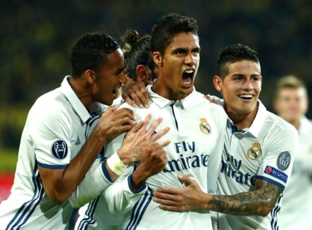 Real Madrid's French defender Raphael Varane (C) celebrates with teammates after scoring a