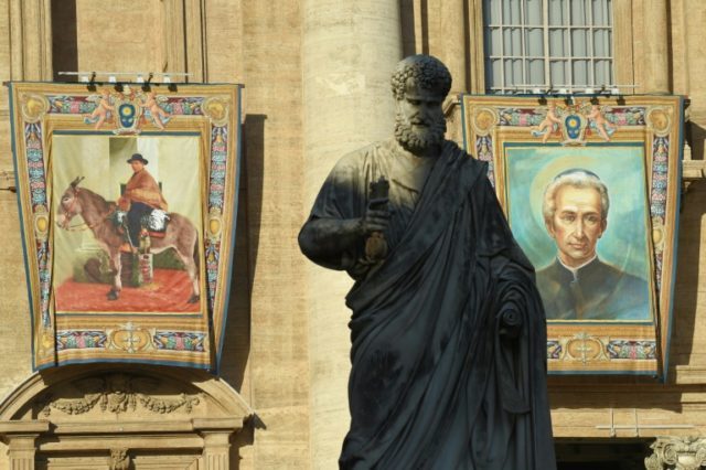 Tapestries on the facade of St Peter's basilica show portraits of Jose Gabriel Brochero (L