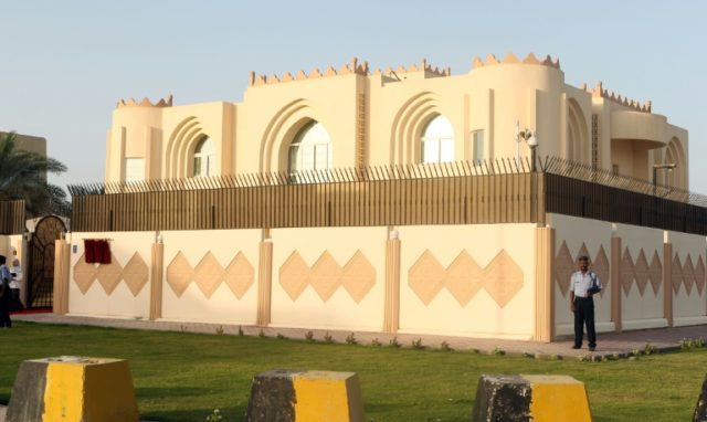 Security guards stand outside the Taliban political office in the Qatari capital Doha