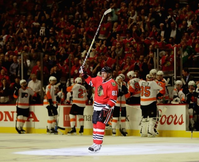 Marian Hossa of the Chicago Blackhawks acknowleges the crowd after scoring his 500th caree