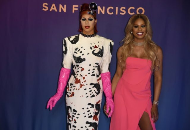 Laverne Cox poses next to a wax figure of herself in the role of Dr. Frank-N-Furter from t