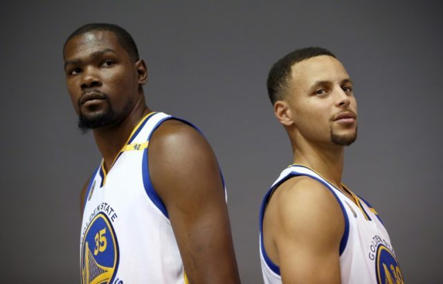 Kevin Durant #35 and Stephen Curry #30 of the Golden State Warriors pose during a media sh