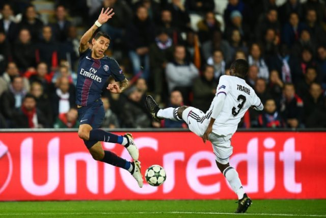 Paris Saint-Germain's forward Angel Di Maria (L) challenges Basel's defender Adama Traore