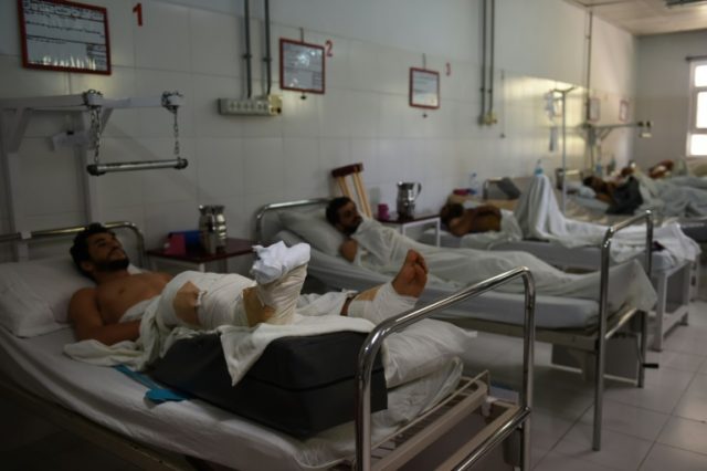 Wounded Afghan men at an emergency hospital in Lashkar Gah, on October 6, 2016