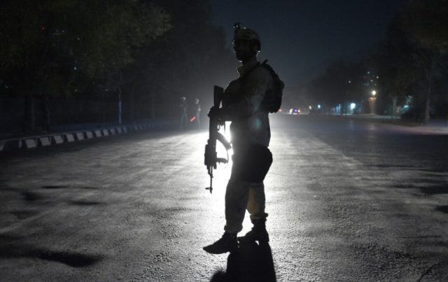 An Afghan security personnel keeps watch near the site of a gun attack in Kabul, on Octobe