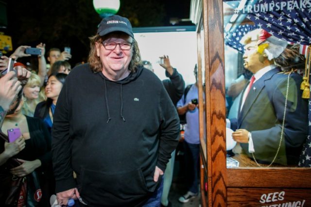 US filmmaker Michael Moore listened to a fortune-telling fairground attraction bearing the