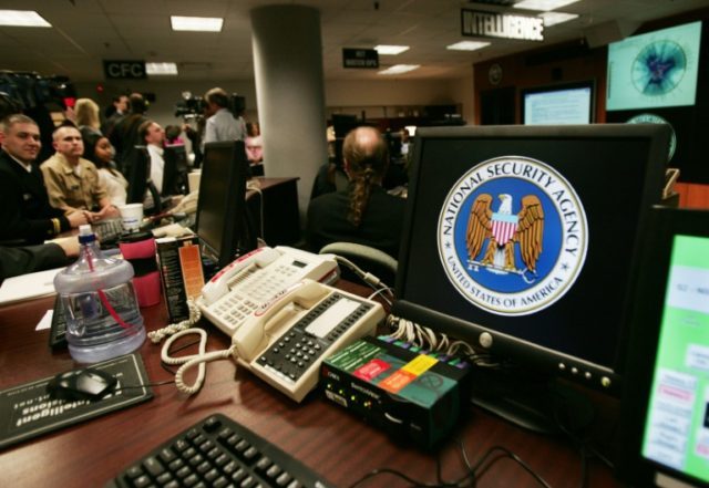 A computer workstation bearing the National Security Agency (NSA) logo is seen inside the