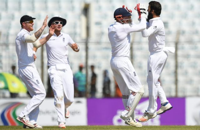 England's Moeen Ali (R) celebrates the wicket of Bangladesh's Imrul Kayes during the secon