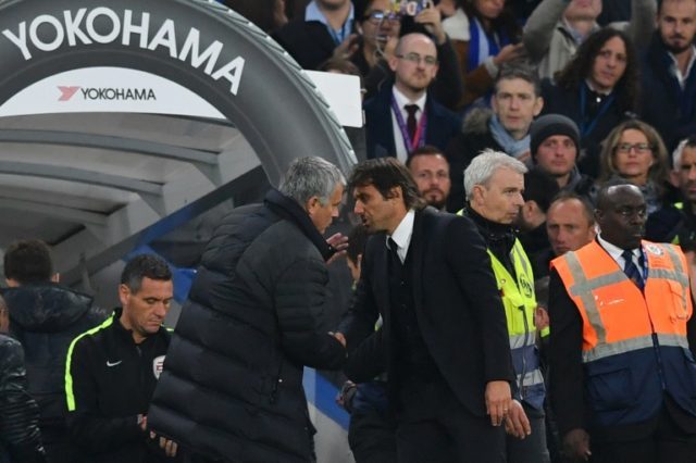 Chelsea's head coach Antonio Conte (R) shakes hands with Manchester United's manager Jose