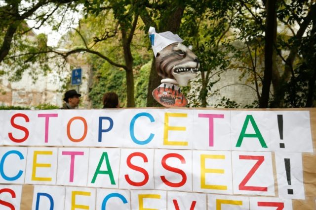 A placard reads 'Stop CETA - it's enough' during a protest against the CETA trade deal in