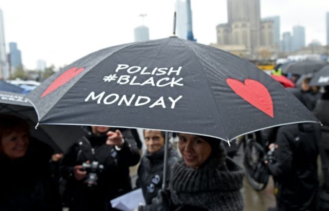 A woman raises her umbrella as a symbol of their protest, as thousands of women launched a