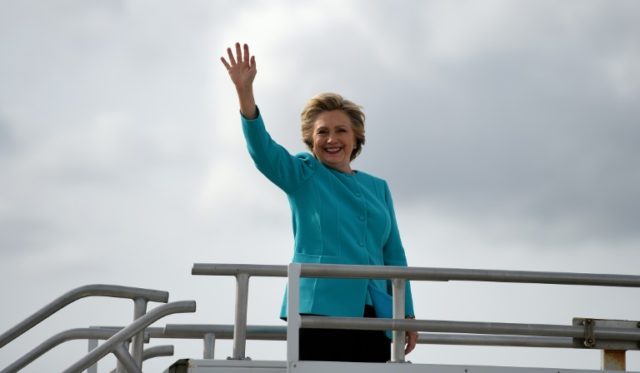 Democratic presidential nominee Hillary Clinton waves on her 69th birthday as she boards h