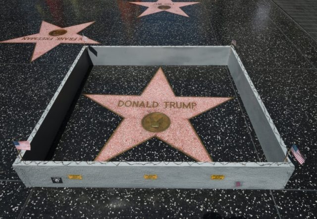 The Hollywood Walk of Fame Star of Republican presidential candidate Donald Trump is surrounded by a miniture barbed-wire wall placed there by Californian street artist Plastic Jesus in July 2016