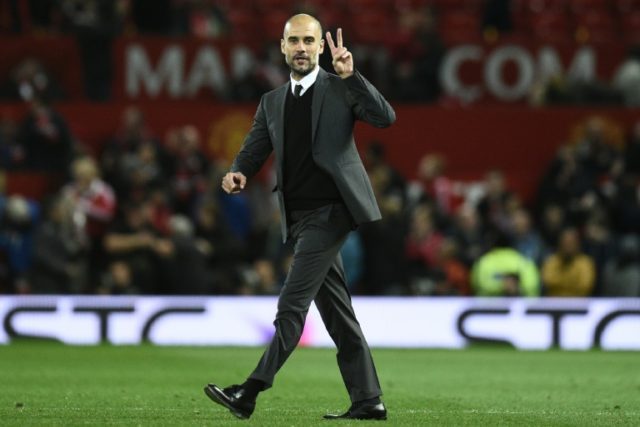 Manchester City's manager Pep Guardiola on the pitch after the English Football League Cup
