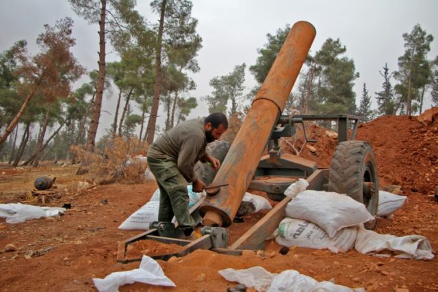 Rebel fighters from the Jaish al-Fatah (or Army of Conquest) prepare to fire a home-made m