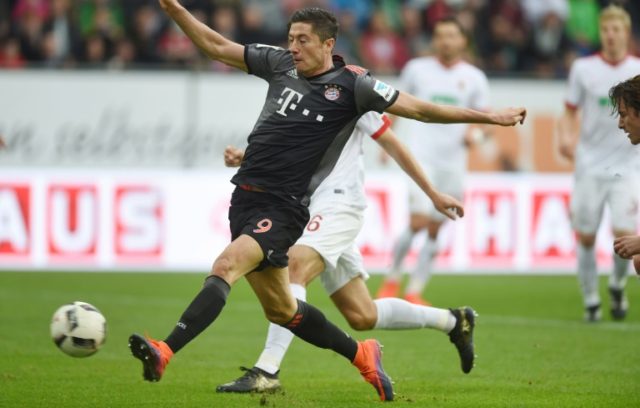 Bayern Munich's striker Robert Lewandowski scores the first goal for Munich during the Ger