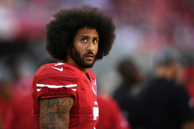 Colin Kaepernick of the San Francisco 49ers looks on from the sidelines during the game ag