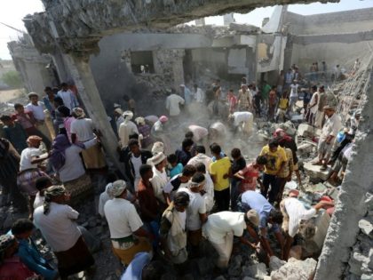 Yemenis gather amidst the rubble at a detention centre hit by Saudi-led coalition air stri