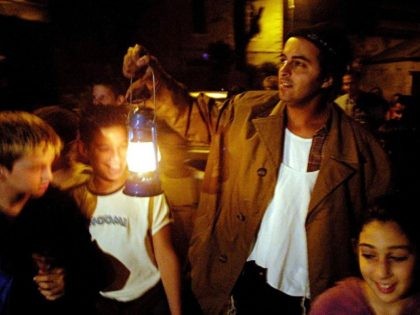Meni Tzabari, an Orthodox Jew, tells stories to a group of school children as he leads them through the streets of the old neighborhood of Nahlaot on their way to a synagogue to pray 'Selihot' or special prayers for forgiveness at 3:30 a.m. September 10, 2002 in Jerusalem, Israel. Many …