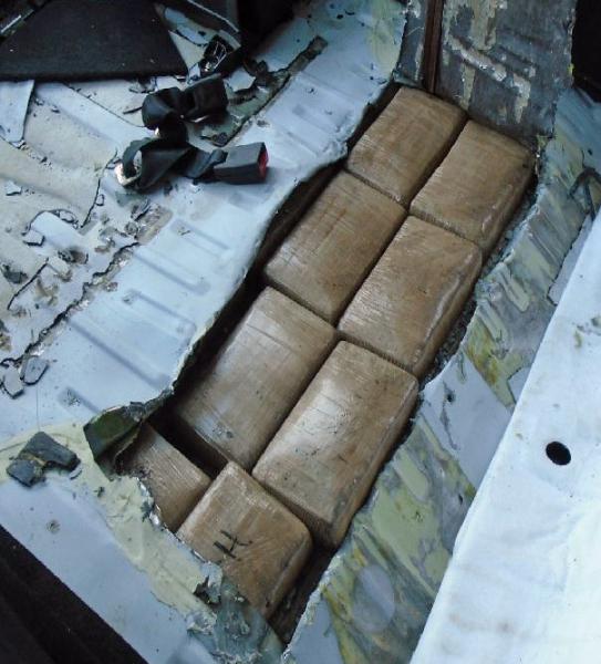 Fourteen packages of cocaine were removed from within the rear cargo area of a smuggling vehicle. (Photo: U.S. Customs and Border Protection)