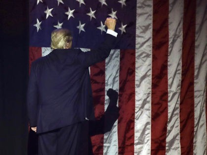 Republican presidential candidate Donald Trump acknowledges supporters as he leaves the st