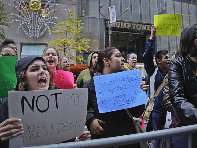 Anti-Trump demonstrators gather outside Trump tower, voicing opposition to Donald Trump's election as President, Wednesday Nov. 9, 2016, in New York. Trump's triumph, declared after midnight, will end eight years of Democratic control of the White House. He'll govern with a Republican-controlled Congress and lead a country deeply divided by …