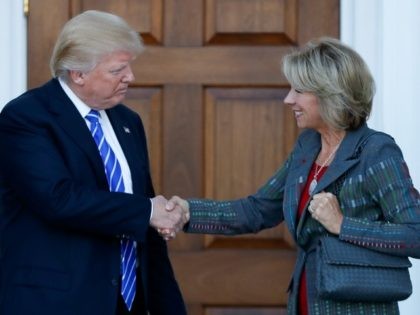 President-elect Donald Trump and Betsy DeVos shake hands at Trump National Golf Club Bedminster clubhouse in Bedminster, N.J., Saturday, Nov. 19, 2016. ()