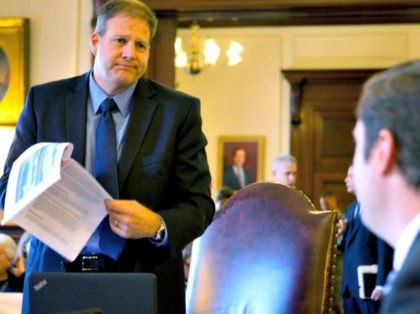 Democratic candidate for governor, Executive Councilor Colin VanOstern, right listens to his Republican rival for governor, Executive Councilor Chris Sununu during the last Executive Council meeting before the election Wednesday, Oct. 26, 2016, in Concord, N.H. (AP Photo/Jim Cole)