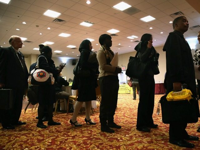 Job seekers line up to meet potential employers at a career fair on April 18, 2013 in New York City.