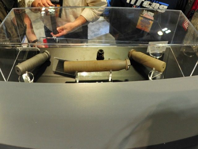 Convention goers look at old rifle suppressors April 11, 2015 at the 2015 NRA Annual Convention in Nashville, Tennessee.AFP PHOTO / KAREN BLEIER (Photo credit should read