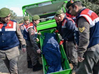 EDITORS NOTE: Graphic content / Turkish gendarmes carry the body of a migrant on a beach i