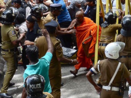 TOPSHOT - Police try to stop demonstrators from marching towards the Central Bank of Sri Lanka building in Colombo on June 24, 2016 Protestors demand the sacking of bank governor Arjuna Mahendran who is accused of a conflict of interest that has allegedly helped a company owned by his son-in-law. …