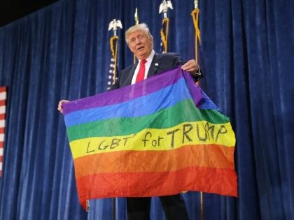 GREELEY, CO - OCTOBER 30: Republican presidential nominee Donald Trump holds an LGBT rainbow flag given to him by supporter Max Nowak during a campaign rally at the Bank of Colorado Arena on the campus of University of Northern Colorado October 30, 2016 in Greeley, Colorado. With less than nine …