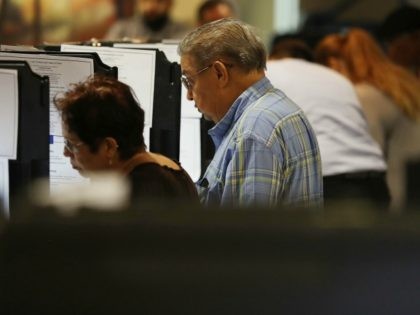 Voters cast their votes at an early voting center setup for the general election on October 31, 2016 in Miami, Florida