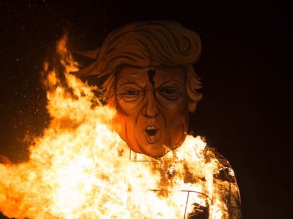 Flames engulf an effigy of US presidential candidate Donald Trump as it is burned as the &