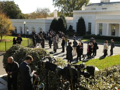 Journalists gather on the driveway in front of the West Wing in anticipation of the arriva