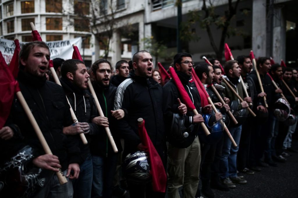 Protesters demonstrate against the visit of the US president around the Polytechnic school in Athens on November 15, 2016. US President Barack Obama is in Greece on a two-day official visit. / AFP / Angelos Tzortzinis (Photo credit should read ANGELOS TZORTZINIS/AFP/Getty Images)