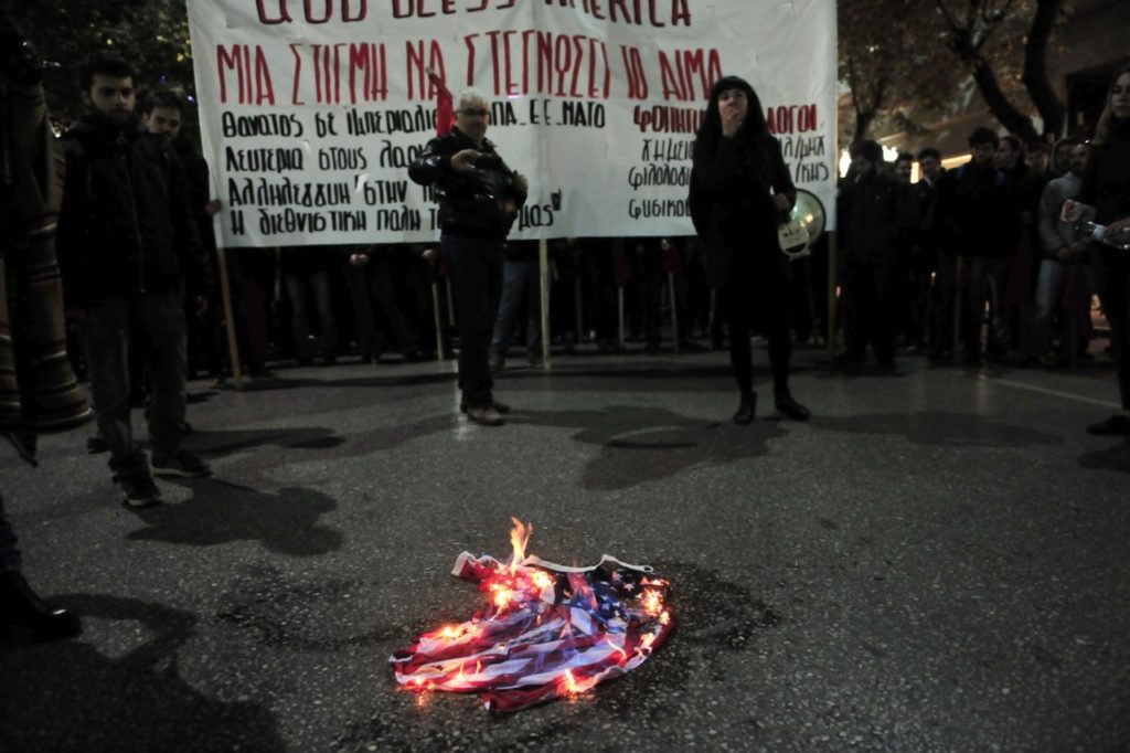 Protestors burn a US flag during a demonstration against the visit of the US president in Thessaloniki on November 15, 2016. US President Barack Obama flew into Athens on his final foreign trip to Europe, seeking to calm the nerves of allies concerned by Donald Trump's shock presidential election victory. / AFP / SAKIS MITROLIDIS (Photo credit should read SAKIS MITROLIDIS/AFP/Getty Images)