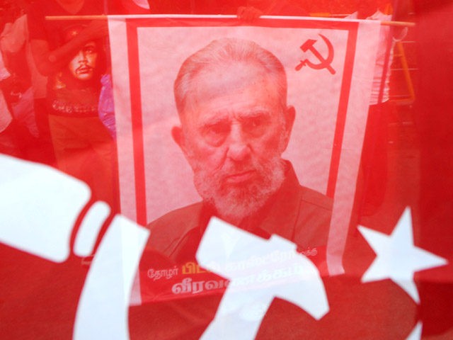 TOPSHOT - Indian members of Communist Party of India carry placards bearing the image of former Cuban president Fidel Castro during a remembrance rally in Chennai on November 26, 2016. Cuba's historic revolutionary leader Fidel Castro died November 25 aged 90, after defying the United States during a half-century of â€¦