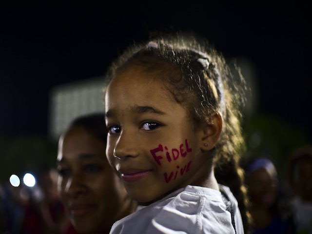 A girl with her face reading "Long Live Fidel" attends a gathering at the Revolution Square to pay homage to late Cuban revolutionary leader Fidel Castro, in Havana, on November 29, 2016. A titan of the 20th century who beat the odds to endure into the 21st, Castro died late Friday after surviving 11 US administrations and hundreds of assassination attempts. No cause of death was given. Castro's ashes will go on a four-day island-wide procession starting Wednesday before being buried in the southeastern city of Santiago de Cuba on December 4. / AFP / RONALDO SCHEMIDT (Photo credit should read RONALDO SCHEMIDT/AFP/Getty Images)