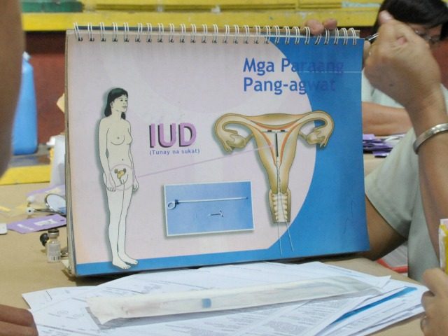 A health worker teaches women how to properly use a intra uterine device (IUD) during the World Population Day in Manila July 11, 2008.