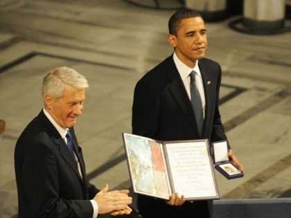 Chairman of the Norwegian Nobel Committee Thorbjoern Jagland (L) applauses as laureate, US President Barack Obama hands the diploma and medal to Nobel Peace Prize, during the Nobel Peace prize award ceremony at the City Hall in Oslo on December 10, 2009.