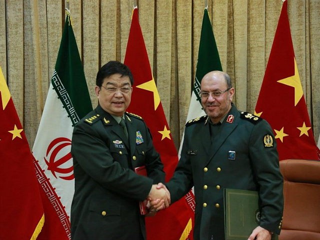 In this picture released by the Iranian Defense Ministry, Iranian Defense Minister Gen. Hossein Dehghan, right, and his Chinese counterpart Chang Wanquan shake hands after exchanging documents of an agreement in Tehran, Iran, Monday, Nov. 14, 2016. Iran's state TV is reporting that Iran and China have signed an agreement …
