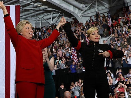 Democratic presidential nominee former Secretary of State Hillary Clinton (C) raises her arms with musicians Jon Bon Jovi (L) and Lady Gaga during a campaign rally at North Carolina State University on November 8, 2016 in Raleigh North Carolina. With one day to go until election day, Hillary Clinton is …
