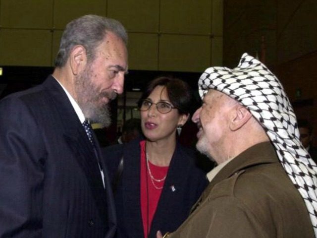 Palestinian leader Yasser Arafat (R) talks with Cuban President Fidel Castro (L) during the opening session of the World Conference Against Racism August 31, 2001 in the coastal city of Durban, South Africa. (Photo by PPO/Getty Images)