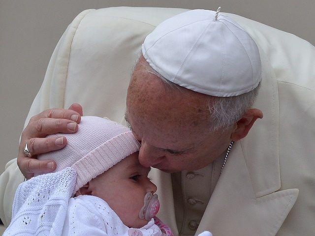 Pope Francis kisses a baby as he arrives for his general audience at St Peter's square on September 24, 2014 at the Vatican. AFP PHOTO / VINCENZO PINTO (Photo credit should read VINCENZO PINTO/AFP/Getty Images)