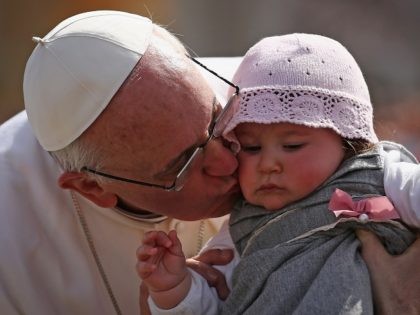 VATICAN CITY, VATICAN - MARCH 24: Pope Francis kisses 8-month-old Victoria Maria Marino from Sicily after delivering his blessing to the palms and to the faithful gathered in St. Peter's Square during Palm Sunday Mass on March 24, 2013 in Vatican City, Vatican. Pope Francis lead his first mass of …