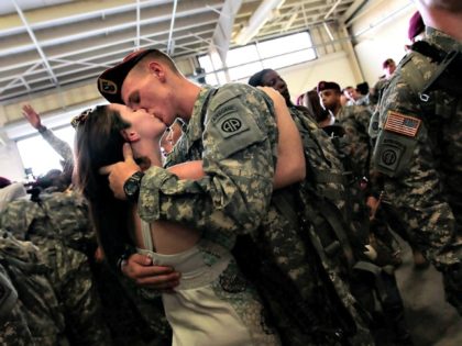Soldier kisses fiancee Getty