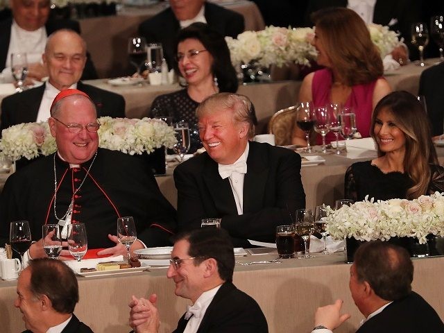 NEW YORK, NY - OCTOBER 20: Sitting between Cardinal Timothy Dolan and his wife Melania Tr